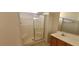 Clean bathroom with shower, vanity sink, and wooden cabinets at 1013 Adobe Flat Dr, Henderson, NV 89011