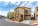 Two-story home with tan exterior, shutters, and a two-car garage at 4177 San Cuervo Way, Las Vegas, NV 89115