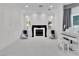 Living room featuring a fireplace, white piano and comfortable seating at 47 Cascade Creek Ln, Las Vegas, NV 89113