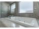 Luxurious bathroom with a soaking tub and walk-in shower at 9621 Verlaine Ct, Las Vegas, NV 89145