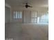 Living room with ceiling fan and sliding doors with shutters at 1652 Black Fox Canyon Rd, Henderson, NV 89052