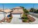 Two story house exterior, front yard, and driveway at 5516 Madigan Ct, Las Vegas, NV 89118