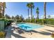 Inviting community pool with lounge chairs and lush landscaping at 5424 Comchec Way # 105, Las Vegas, NV 89108