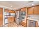 Kitchen boasts stainless steel appliances and wood cabinetry at 3133 La Mancha Way, Henderson, NV 89014