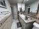 Clean bathroom features granite countertop, updated vanity, and tiled floors at 2913 Domino Way, Las Vegas, NV 89117