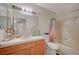 Clean bathroom with shower/tub combo and wood vanity at 4836 Camino Pacifico, North Las Vegas, NV 89031