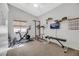 A home gym with exercise equipment, a TV, and motivational posters at 6024 Resort Ridge St, Las Vegas, NV 89130