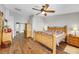 Large main bedroom with wooden furniture, ceiling fan, and wood-look flooring at 6024 Resort Ridge St, Las Vegas, NV 89130