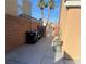 Small backyard with concrete patio and trash cans at 1833 Oak Bluffs Ave, North Las Vegas, NV 89032