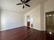 Spacious bedroom with wood floors, ceiling fan and bathroom access at 6495 Coldwater Bay Dr, Las Vegas, NV 89122