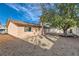 Sunny backyard with gravel ground cover and a large tree at 3719 Lorraine Ln, Las Vegas, NV 89120