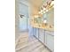 Bathroom with double vanity, light gray cabinets, and wood-look floors at 6745 Keren Marie Ave, Las Vegas, NV 89110