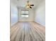 Bright bedroom featuring wood-look floors and ceiling fan at 6745 Keren Marie Ave, Las Vegas, NV 89110