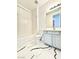 Clean bathroom with a shower/tub combo, vanity, and marble-look floors at 6745 Keren Marie Ave, Las Vegas, NV 89110