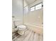 Clean bathroom with a tub, toilet and wood-look floors at 6745 Keren Marie Ave, Las Vegas, NV 89110