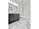 Bathroom with dark vanity, bathtub and marble flooring at 6745 Keren Marie Ave, Las Vegas, NV 89110