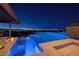 Luxury pool with city views at night; perfect for entertaining at 1492 Macdonald Ranch Dr, Henderson, NV 89012