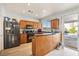 Kitchen with wood cabinets, stainless steel appliances, and a breakfast bar at 6046 Notre Dame Ave, Las Vegas, NV 89110