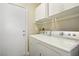 Bright laundry room with washer, dryer, and cabinets at 6046 Notre Dame Ave, Las Vegas, NV 89110