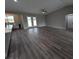 Spacious living room with gray walls, hardwood floors, and access to backyard at 1240 E Lewis St, Pahrump, NV 89048