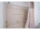 Bathroom with shower/tub combo and tiled walls at 2851 S Valley View Blvd # 2148, Las Vegas, NV 89102