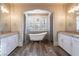 Elegant bathroom with freestanding tub, dual vanity, and chandelier at 453 Punto Vallata Dr, Henderson, NV 89011