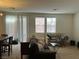 Living room with brown sofa, table, and dining area at 6255 W Arby Ave # 239, Las Vegas, NV 89118