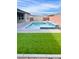 Inviting backyard oasis with a sparkling pool, modern grill, and lush green artificial turf at 5714 Golden Chase Ct, Las Vegas, NV 89131