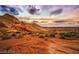 Desert landscape with colorful rock formations and sunset sky at 5714 Golden Chase Ct, Las Vegas, NV 89131