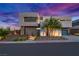 Modern home exterior features clean lines, landscaping, and a two-car garage at 21 Canyon Bay Dr, Henderson, NV 89011