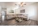 Spacious living room featuring a large sectional sofa and wood-look flooring at 1228 Oak Village Ave, Las Vegas, NV 89183