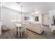 Open dining area with white table and chairs near the living room at 1228 Oak Village Ave, Las Vegas, NV 89183