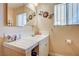 Bright bathroom with single sink vanity, tiled floor, and shower/tub combo at 208 Prince Ln, Las Vegas, NV 89110