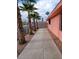 Long concrete walkway next to the house and palm trees at 5212 Rou Cir, Las Vegas, NV 89122