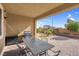 Covered patio with seating area, grill, and view of backyard at 9611 Bruschi Ridge Ct, Las Vegas, NV 89149