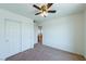 Simple bedroom with double doors and ceiling fan at 6442 Kobe Knoll Ct, Las Vegas, NV 89141