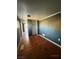 Small bedroom with wood floors and dark walls at 11 Avenue I, McGill, NV 89318