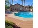 Community pool with lounge chairs and surrounding patio at 2110 Los Feliz St # 1028, Las Vegas, NV 89156