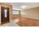 Welcoming living area with wood-look flooring, decorative front door, and abundant natural light at 7604 Charles Conrad Cir, Las Vegas, NV 89145