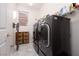 Laundry room with dark gray washer and dryer set at 3013 Noblesville Ct, Henderson, NV 89052