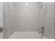 Clean bathroom with a bathtub and gray tile surround at 477 Highview Ridge Ave, Las Vegas, NV 89138