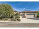 Single-story house with two-car garage, landscaping, and stone accents at 2112 Silent Echoes Dr, Henderson, NV 89044