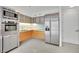 Modern kitchen with stainless steel appliances and orange cabinets at 3722 Las Vegas Blvd # 2101, Las Vegas, NV 89158