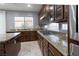 Kitchen features granite counters, dark wood cabinets, and gas cooktop at 9630 Desert Daisy Ct, Las Vegas, NV 89178