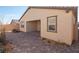 Paved backyard patio with fire pit, landscaping, and covered patio at 10972 Chipotle Ave, Las Vegas, NV 89166