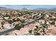 Aerial view of a residential neighborhood with golf course and mountain views at 2820 Lotus Hill Dr, Las Vegas, NV 89134