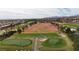 Aerial view of a golf course with a pond and driving range at 2820 Lotus Hill Dr, Las Vegas, NV 89134