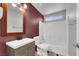 Bathroom with maroon walls, white tub/shower, and wood vanity at 4613 Painted Cliffs Dr, Las Vegas, NV 89108