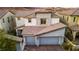 Modern two-story home with gray and white exterior and two-car garage at 20 Papavero Ct, Henderson, NV 89011