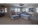 Bright bonus room featuring a comfy sectional sofa and large windows at 7125 Mountain Den Ave, Las Vegas, NV 89179